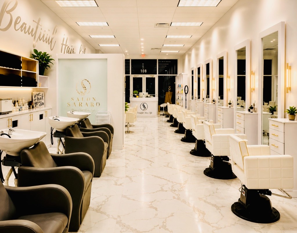 Salon Sararo after: marble floors, white styling stations with gold accents, Beautiful Hair script